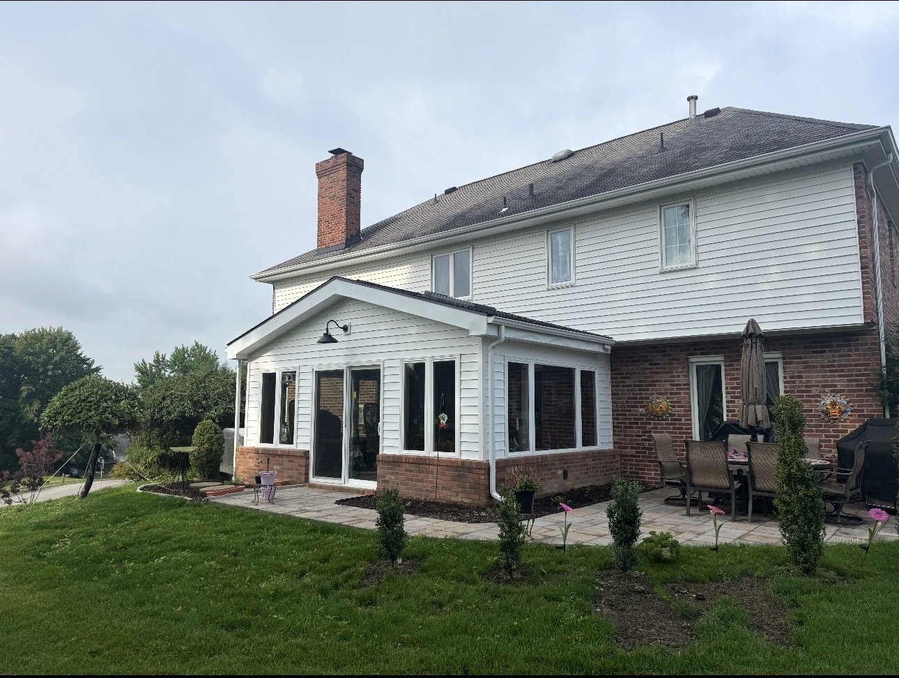 Completed sunroom addition on a brick home